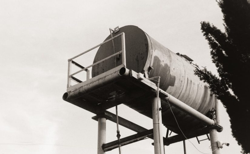 A water tank sits atop a tall metal structure.